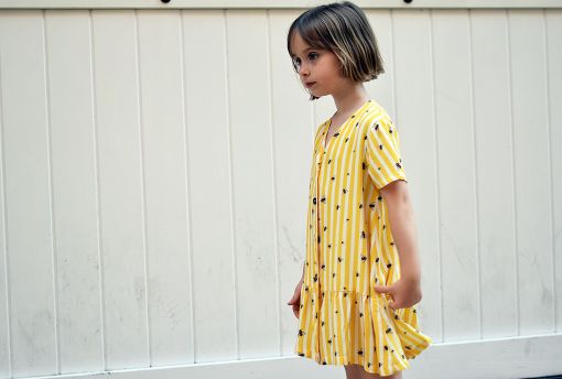Vestido infantil Moscas, hecho en viscosa, de manga corta, con estampado de moscas y rayas amarillas. Hecho en España de manera sostenible.